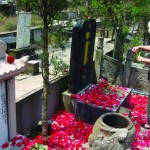 My mother. Spreading flower petals on the tombs of my grandma (with white tombstone) and my father. On Father’s tombstone is also Mother’s name, covered by a piece of fabric, which will be peeled off when she dies and her ashes join his.