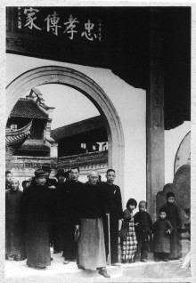 A downcast Chiang Kai-shek visiting his ancestral temple for the last time before leaving Mainland China in 1949, with his son and heir, Ching-kuo (to left in hat).