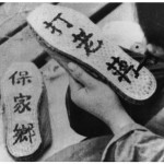 Painting slogans on the soles of 'liberation shoes' during the civil war - 'Safeguard Our Land' (left) and 'Beat Chiang Kai-shek'. 