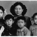My mother with (from left) Xiao-hong, Jin-ming, Xiao-hei, and me, Chengdu, early 1958.  This photograph was taken in a hurry for my father to bring with him to Yibin to show his mother, who was gravely ill.  Signs of haste show in my mother's hair, which has not been brushed down, and in the handkerchief still pinned (as was customary for young children) to Jin-ming's sailor suit.