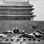 A caravan of camels passing in front of a Beijing city gate.  It was said that some five thousand camels came into Beijing every day.